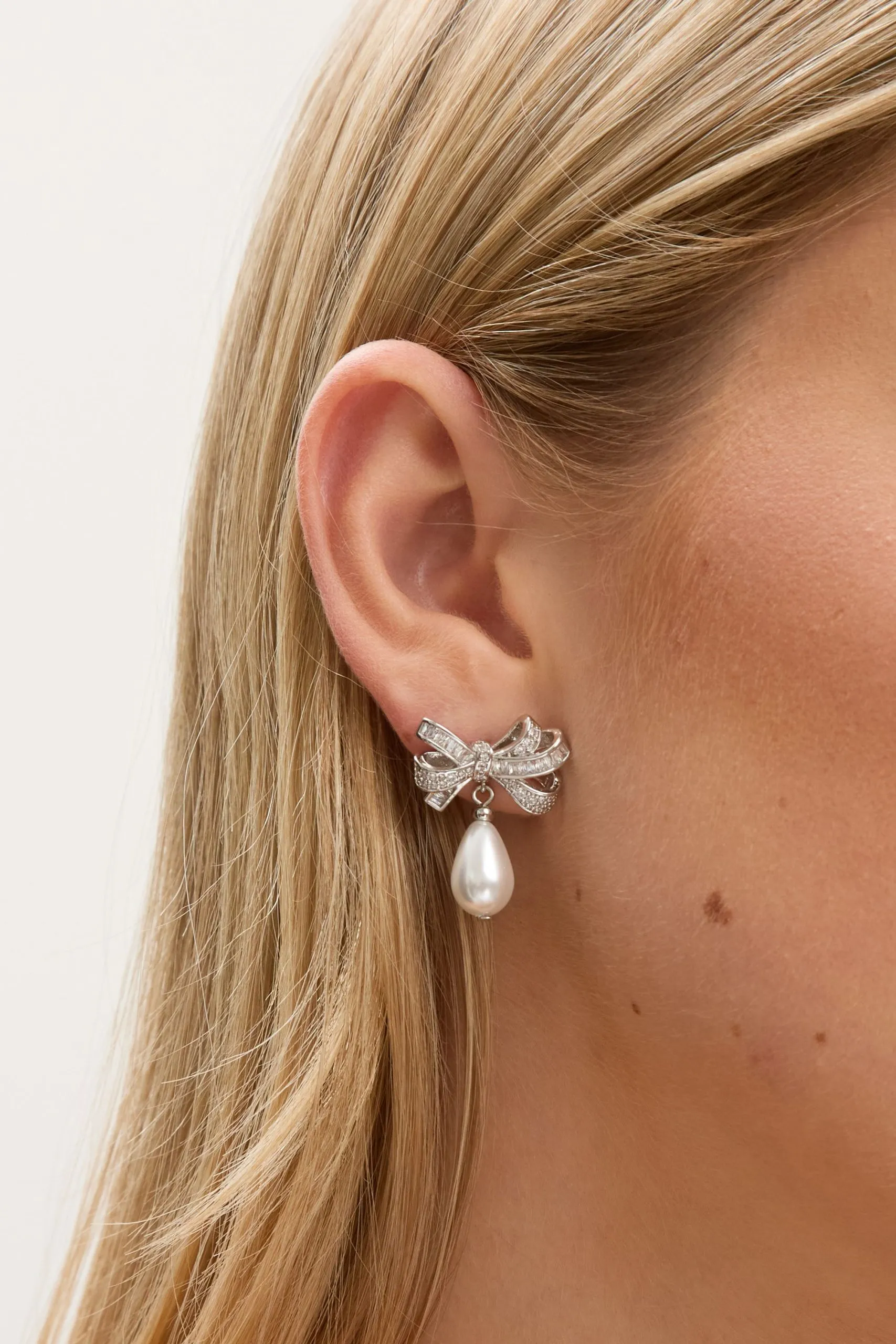 Rhodium Plated Cubic Zirconia Bow and Pearl Earrings